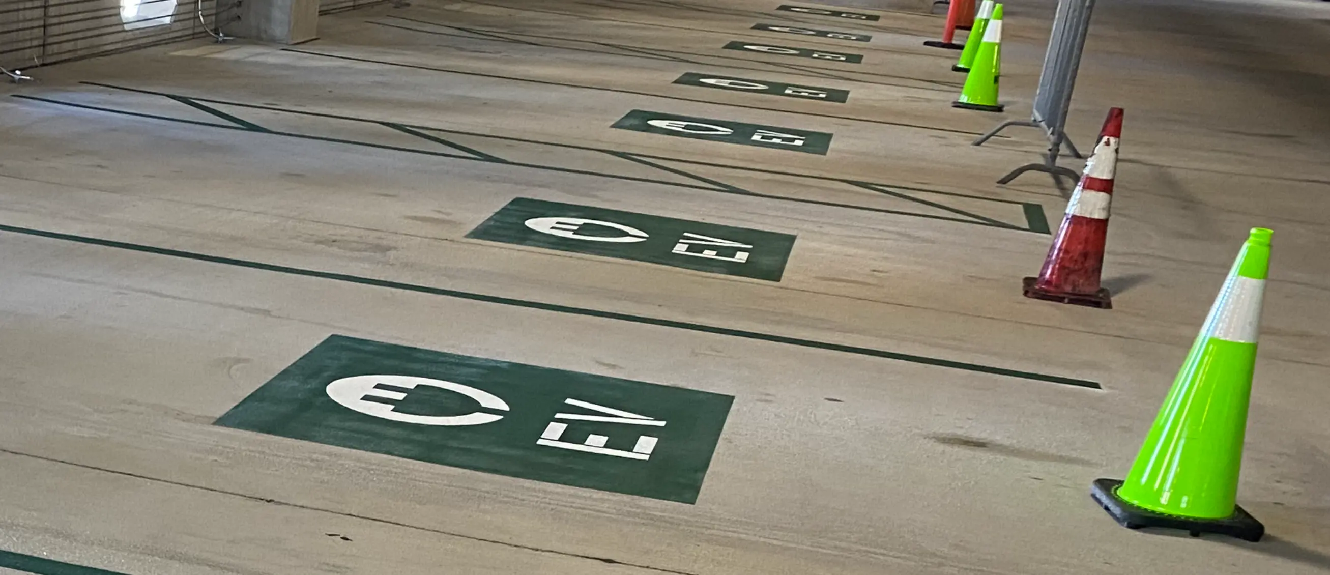 Custom parking stencils New Orleans — EV charging station markings in parking garage